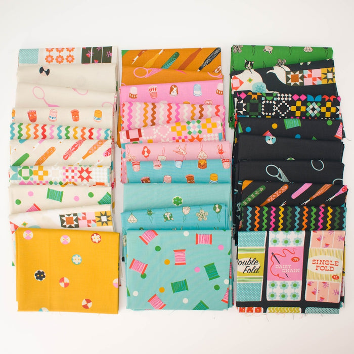 A collection of folded fabric swatches arranged in three vertical columns on a white background. The fabrics feature various colorful sewing notion themed patterns including quilting motifs, scissors, spools of thread, and retro designs in shades of pink, yellow, green, orange, black, and white.