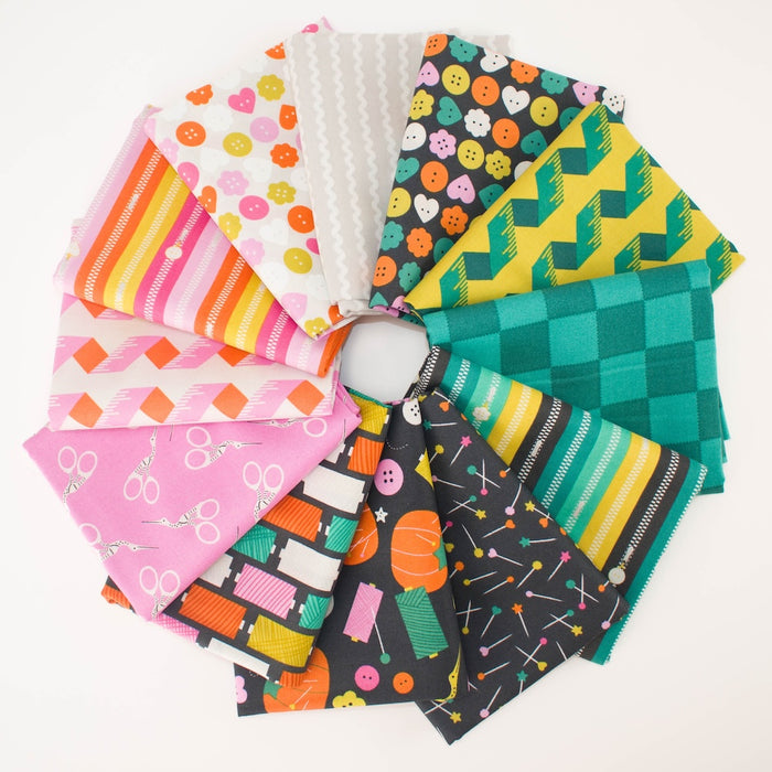 A circular arrangement of colorful patterned fabrics on a white background. Sewing themed prints including buttons, pins, zippers, scissors, thread spools, and checkers.