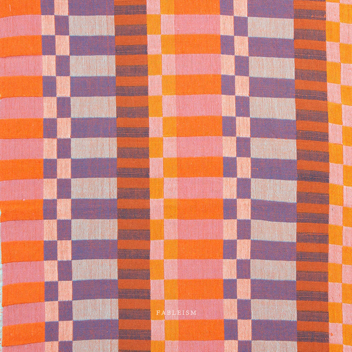 Plaid pattern fabric swatch in orange, purple, and pink.