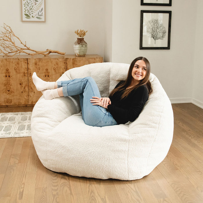 Girl laying back on a chair in the living room #color_icing-teddy-boucle
