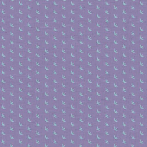 A close-up of a lavender purple textured fabric with a repeating pattern of small light blue birds.