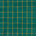 A close-up of a teal green fabric with a yellow grid plaid pattern.