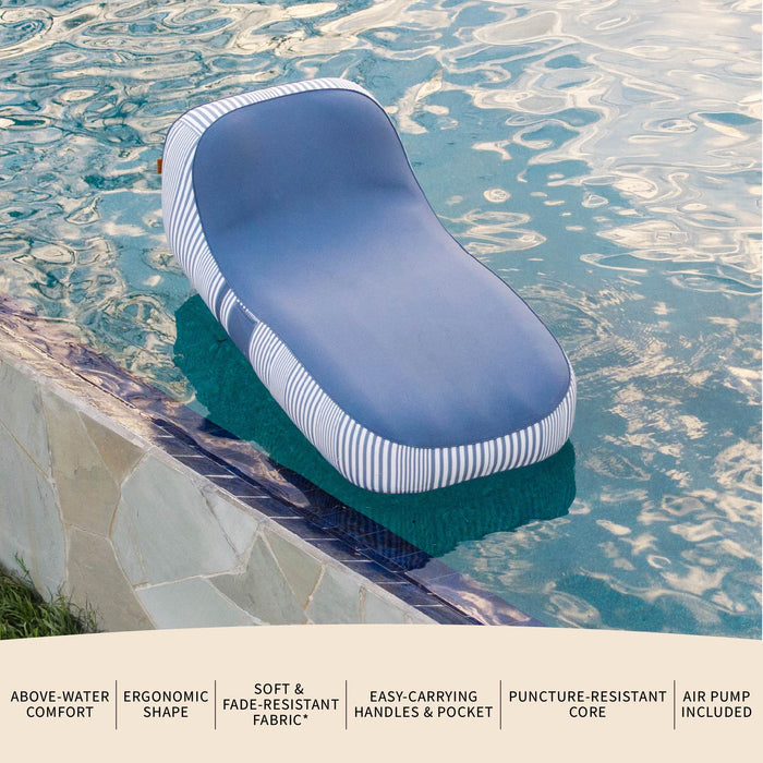 Inflatable lounge chair with striped design in a pool #color_weekend-navy-stripe-olefin