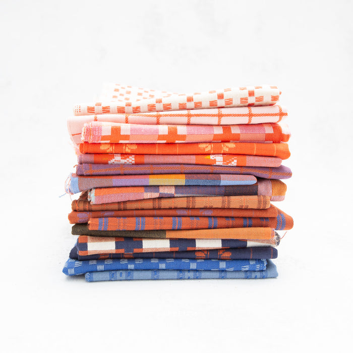 Stack of colorful folded fabrics on a white background