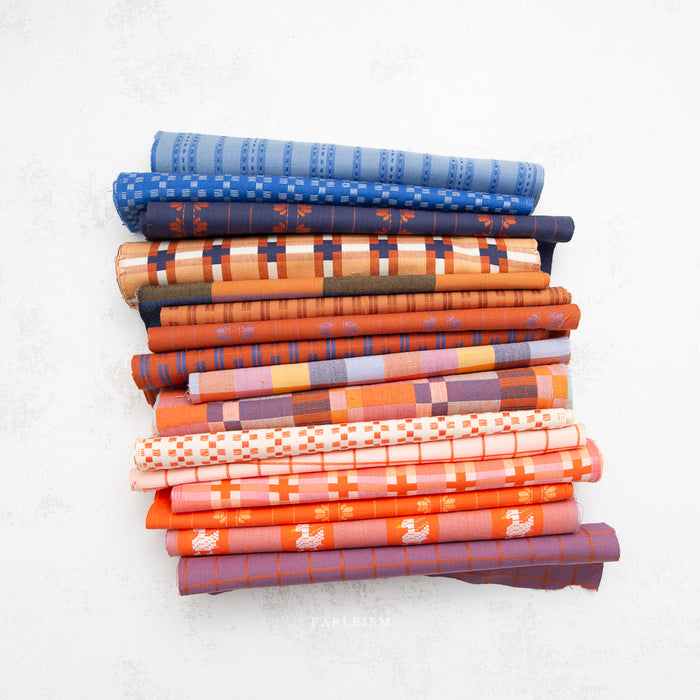 Stack of colorful folded fabric on a white background