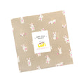 Fabric layer cake with bunny pattern and Ruby Star Society LoFi label on a white background