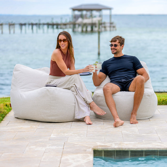 Couple on the Luft Outdoor Patio Chair #color_sunlit-ivory-outdoor-performance-linen