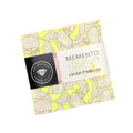 Packaged product with 'Memento' label and yellow abstract pattern on a white background
