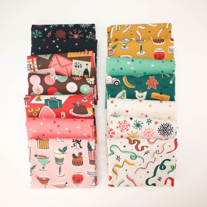 Two stacks of folded fabric with various colorful holiday-themed patterns, including cocktails, desserts, snowflakes, and gingerbread men, displayed on a clean white background.