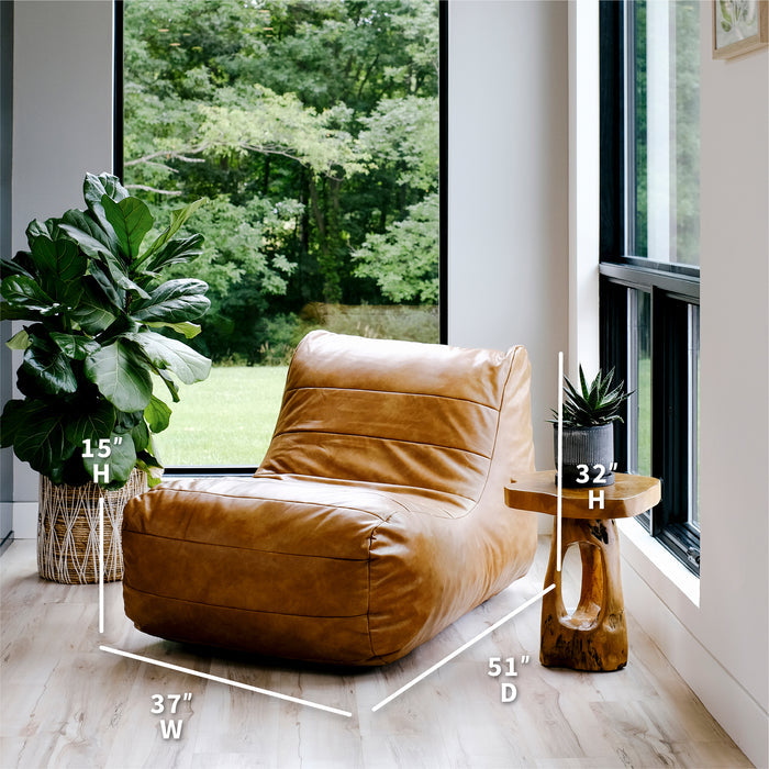 Brown leather chair in a room with a large window and plants #color_copper-harbor-premium-vegan-leather