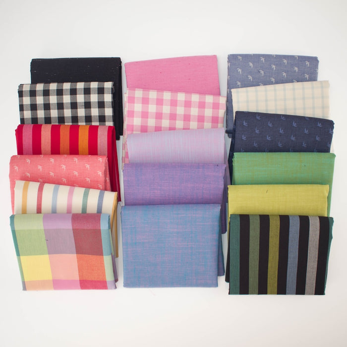 A collection of folded fabric squares in various colors and patterns, including stripes, plaid, and solid textures, arranged in three columns on a plain white background.