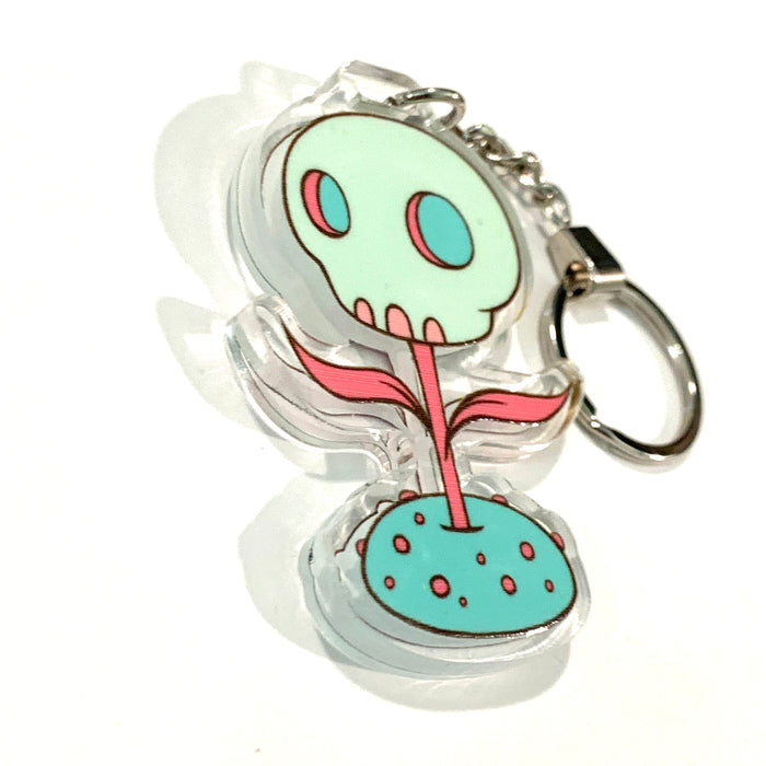 Skullfower keychain, skull with a stem and leaves set in crystal clear acrylic with chain and key ring.