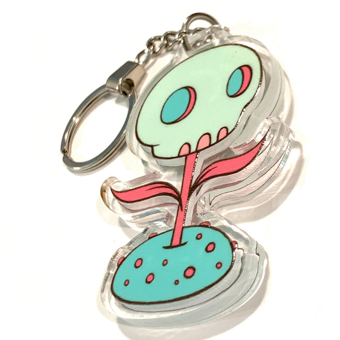 Skullfower keychain, skull with a stem and leaves set in crystal clear acrylic with chain and key ring.