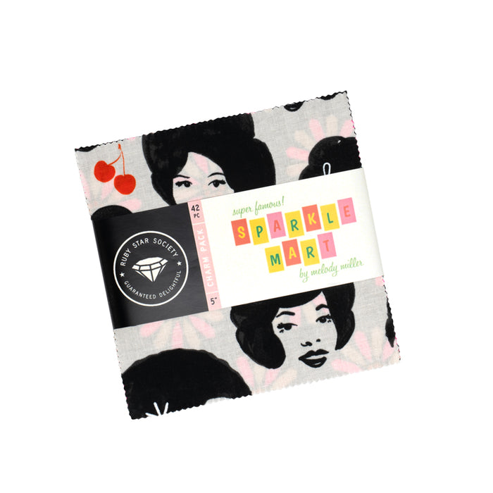 Fabric bundle of 5" squares with face designs and a label reading Sparkle Mart on a white background