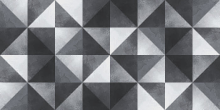 Geometric pattern of triangles in black, white, and gray on a textured surface.
