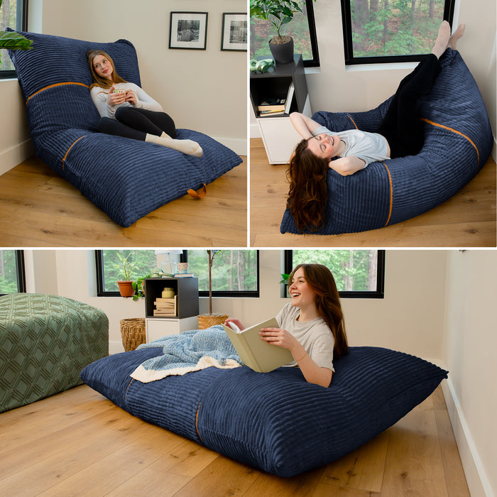 A three-panel collage showing a woman lounging on a large navy ribbed floor cushion in a bright room. In the top-left panel, she sits cross-legged on the cushion. #color_midnight-blue-corded-plush
