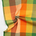 Close-up of a checkered fabric with orange, yellow, and green colors.