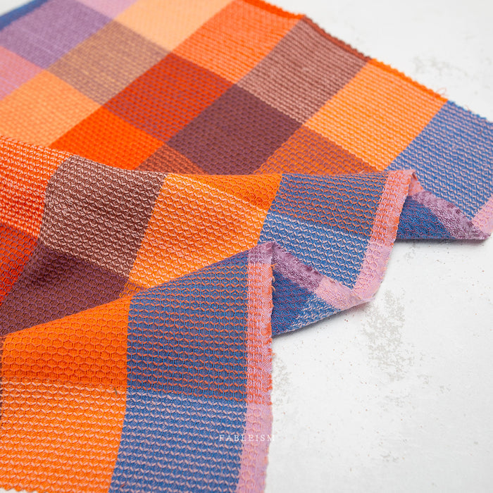 Colorful checkered fabric swatches on a white background